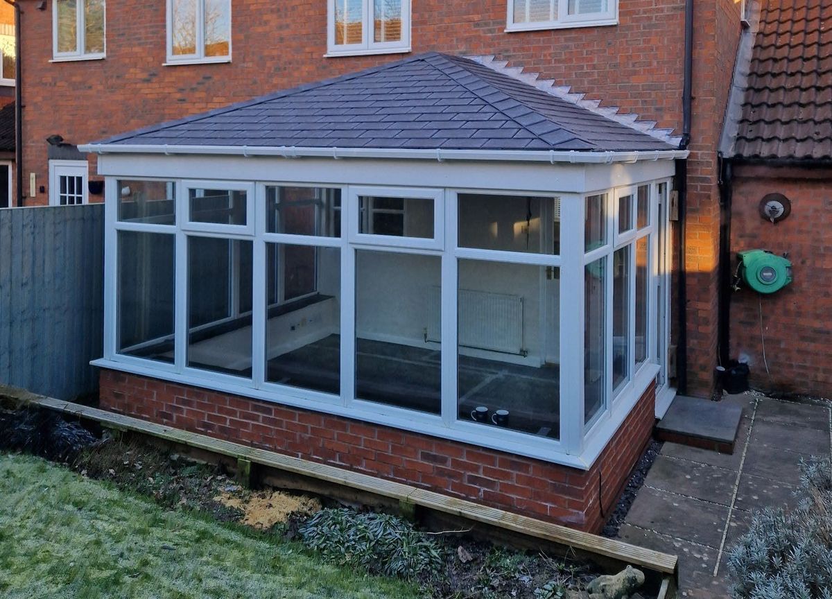 After: polycarbonate roof replaced with a tiled roof in Pewter Grey
