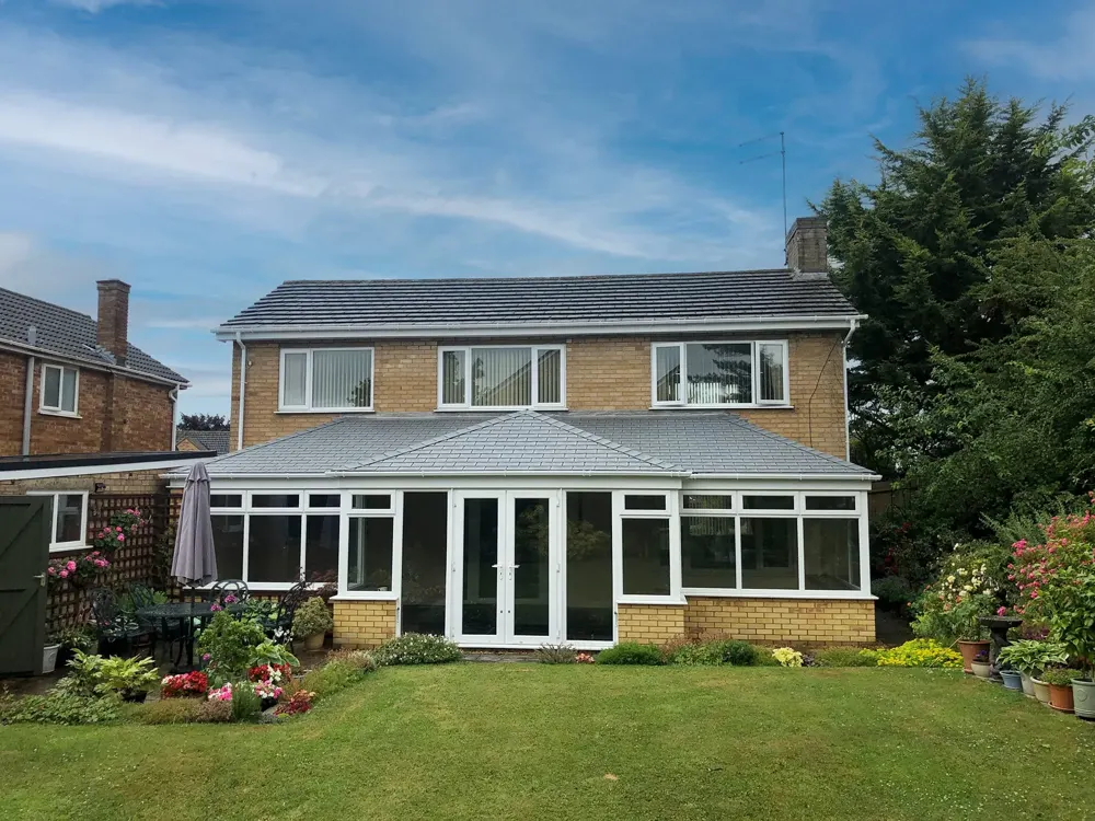T Shape conservatory with a tiled roof fitted by Nu-Look